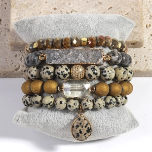Detail of 5PCS bohemian stacked bracelets with natural stone and crystal on display pillow