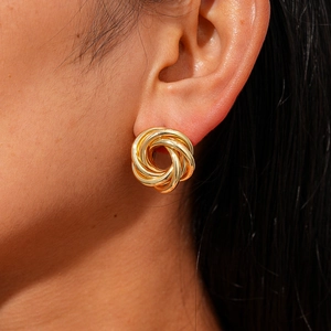 Elegant gold knot earring set with pearl and floral accents shown on model for women