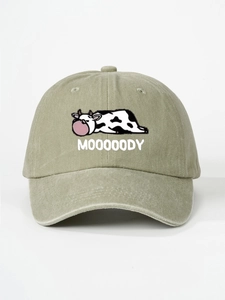 Close-up detail of cartoon cow embroidery and MOOOOODY text on washed khaki cotton cap