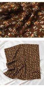 Macro detail of brown floral cotton linen scarf with elegant yellow prints and white edges