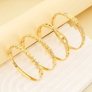 Detail view of 18K gold plated geometric bangles with zircon inlay on white wave stand