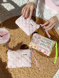Floral quilted mini pouch with cherry print and bow detail for small makeup storage