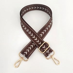 Adjustable brown nylon shoulder strap with white chevron pattern and gold metal hooks