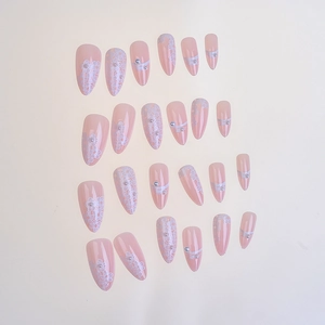 Detailed view of 24pcs pink almond press-on nails with white lace flower and pearl accents