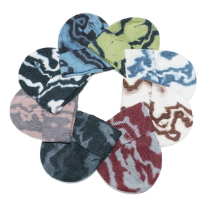 Knitted tie-dye beanie hats in multiple colors arranged in a circle on white background