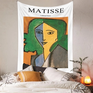 Detail view of Matisse abstract portrait tapestry hanging on a white bedroom wall