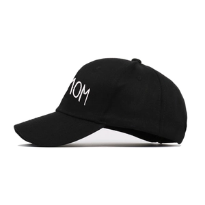 Classic black cotton baseball cap with white MOM embroidery and curved brim in side view