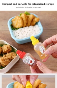 Handheld mini squeeze bottles for tomato ketchup and honey mustard in a lunch bento box