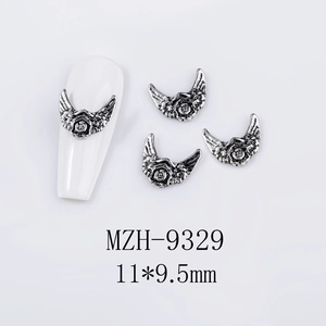 Macro view of retro silver metal wings nail art charm with size 11x9.5mm detail
