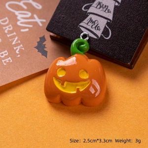 Close-up of resin pumpkin pendant for Halloween DIY crafts with 2.5cm by 3.3cm dimensions