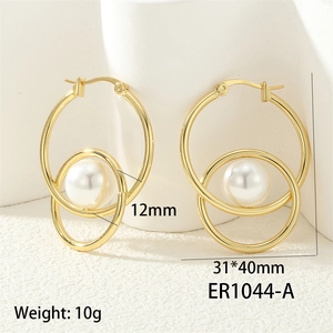 Macro detail of gold-plated twisted hoops with 12mm pearl and zircon inlay