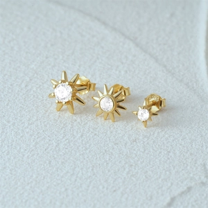 Detailed view of three sized S925 silver starburst earrings with sparkling cubic zirconia