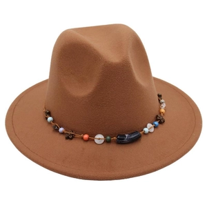 Detail of bohemian colorful beaded band with wooden flowers on brown felt fedora hat