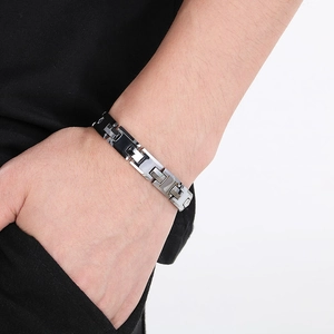 Close-up of adjustable silver and black H-link chain bracelet worn on male wrist