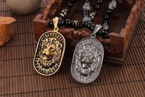 Detail view of retro gold and silver lion head pendants on black beaded necklaces