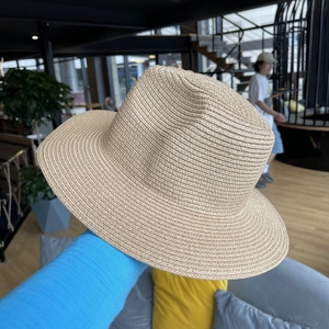 Detailed view of beige woven straw fedora hat with fine texture for sun protection