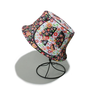 Vibrant floral and peace sign printed bucket hat for women's outdoor sun protection