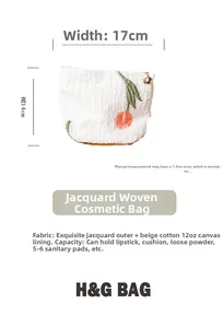 Detail of white jacquard makeup bag with orange tulip embroidery and flower zipper puller