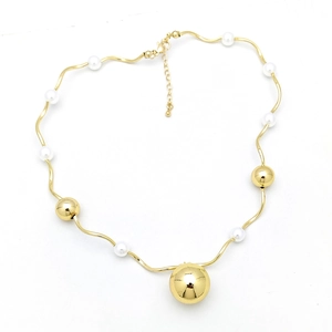 Detail of gold wavy chain necklace with white pearls and polished metallic beads