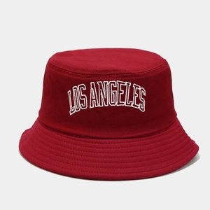 Detail of red bucket hat with white Los Angeles embroidery and premium cotton texture