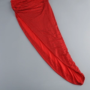 Detailed close-up of a red sequined evening gown featuring side slit and ruched fabric design