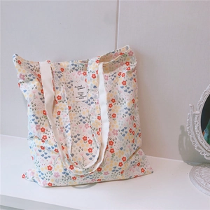 Detail of floral cotton tote bag with vintage botanical prints and woven textile label