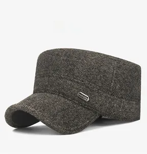 Detail of dark brown herringbone wool blend military cap with side metal logo accent