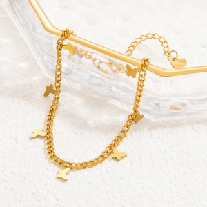 Macro shot of 18k gold plated butterfly charm anklet with S.Steel engraving detail