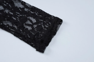 Close-up of black lace dress sleeve showing intricate floral embroidery and sheer mesh