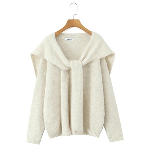Detail of cream-white knit sweater featuring a stylish integrated scarf-style shawl collar