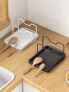 Modern dual-slot kitchen rack holding a pot lid and cooking utensils on a wooden counter