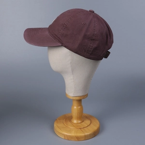 Detail of washed cotton baseball cap with adjustable metal buckle and breathable side holes