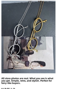 Macro shot of minimalist silver and gold glasses frame pendants on matte alloy necklaces