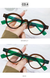 Detail view of round glasses SZ2003 with brown frames and green transparent temples