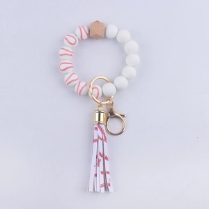 Dettagli delle perle da baseball in silicone bianco con nappa rossa e portachiavi dorato