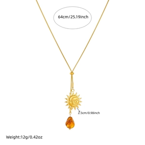Vintage sun and moon necklace with amber drop pendant on long gold chain