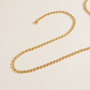 Macro shot of gold heart-shaped link chain necklace with a secure lobster clasp