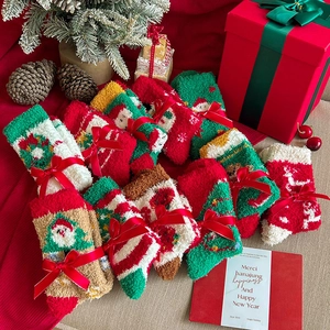 Detailed view of warm Christmas coral fleece socks with festive ribbons and holiday patterns