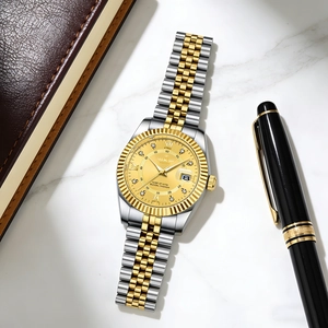 Detailed close-up of gold-tone men's watch with diamond markers and date window