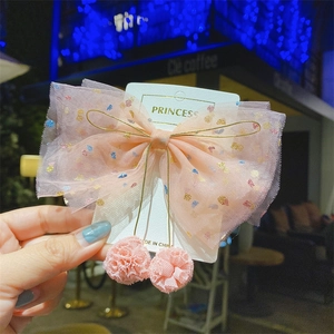 Pink tulle bow hair clip with colorful sequins and soft pom-poms for girls