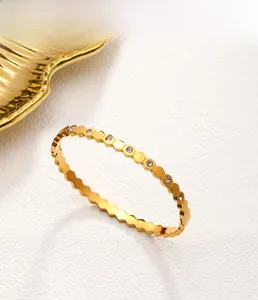 Detail of 18K gold-plated honeycomb bangle with embedded sparkling zircon crystals