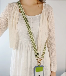 Detail of adjustable crossbody phone strap with leaf embroidery and pearl charm