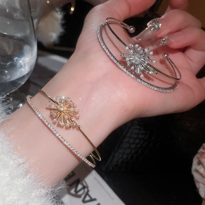 Close-up of double-layer zircon and pearl firework open bracelets in gold and silver finish