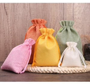 Close-up of colorful linen drawstring pouches in pink, orange, yellow, and green colors