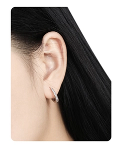Macro detail of S925 sterling silver hoop earring with pavé zircon setting on ear