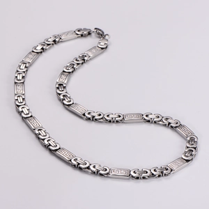 Detailed macro view of Byzantine silver necklace with Greek key pattern on chain links