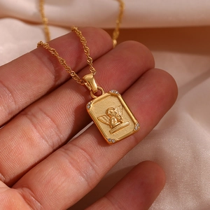Detail of gold angel relief pendant with zircon corners and twisted rope chain