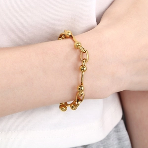 Minimalist gold link bracelet for women featuring oval rings and spherical beads design