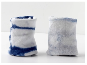 Macro detail of blue and white tie-dye fabric texture on soft cotton sports wristbands
