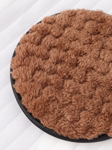 Close-up of the soft brown plush makeup sponge with durable black stitched edge finish